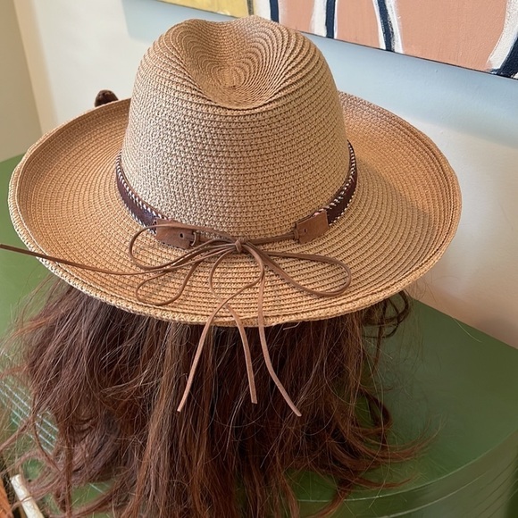 Cowboy hat. It’s tan with a gold shimmer